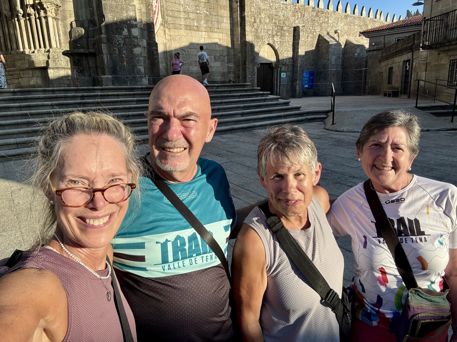 Four friends in an evening selfie at the foot of the cathedral steps in Tui.